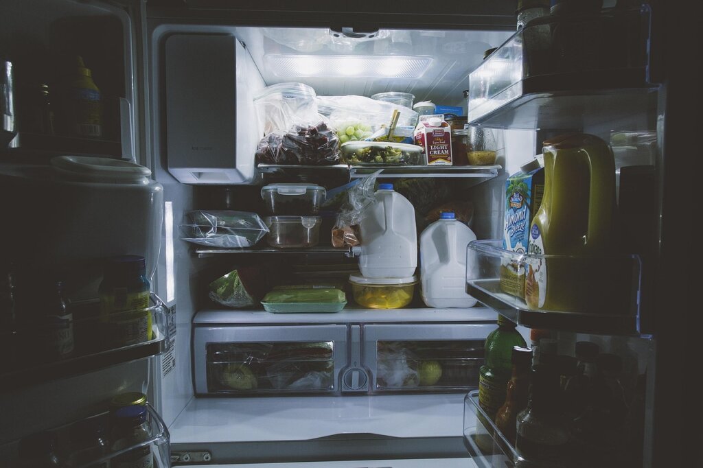 baking soda in open container placed inside refrigerator shelf