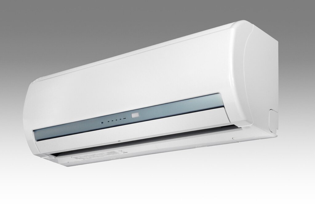 air conditioner remote control with sleep timer function highlighted in dark bedroom