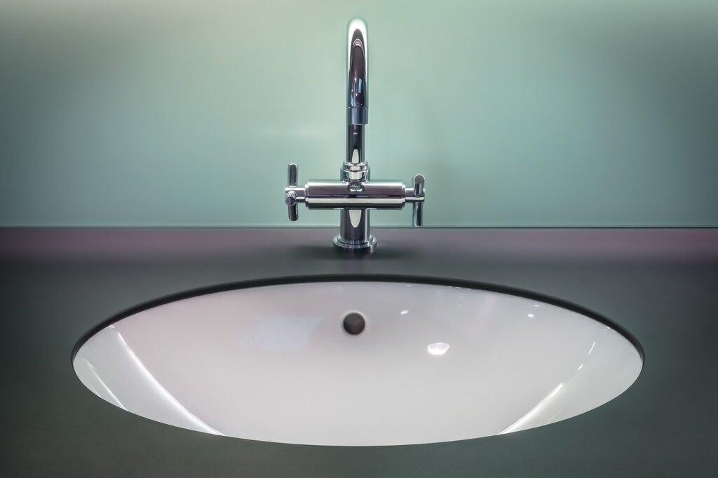 white mineral limescale buildup on bathroom faucet