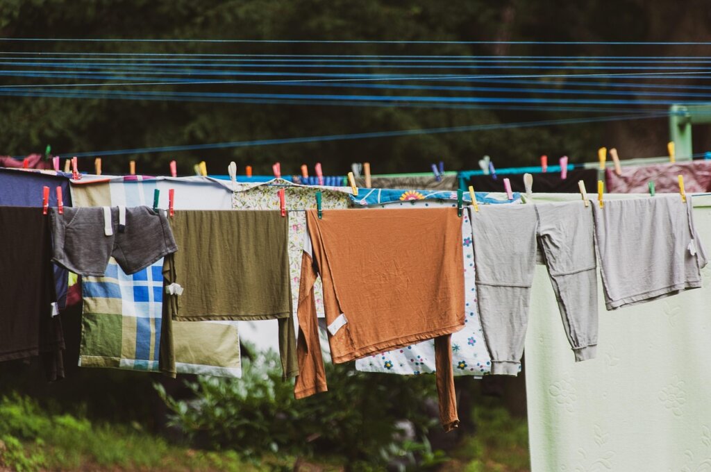 clothing care label tags with laundry symbols on fabric