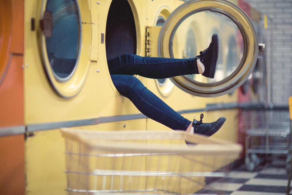 washing machine drum after cleaning cycle with black debris floating