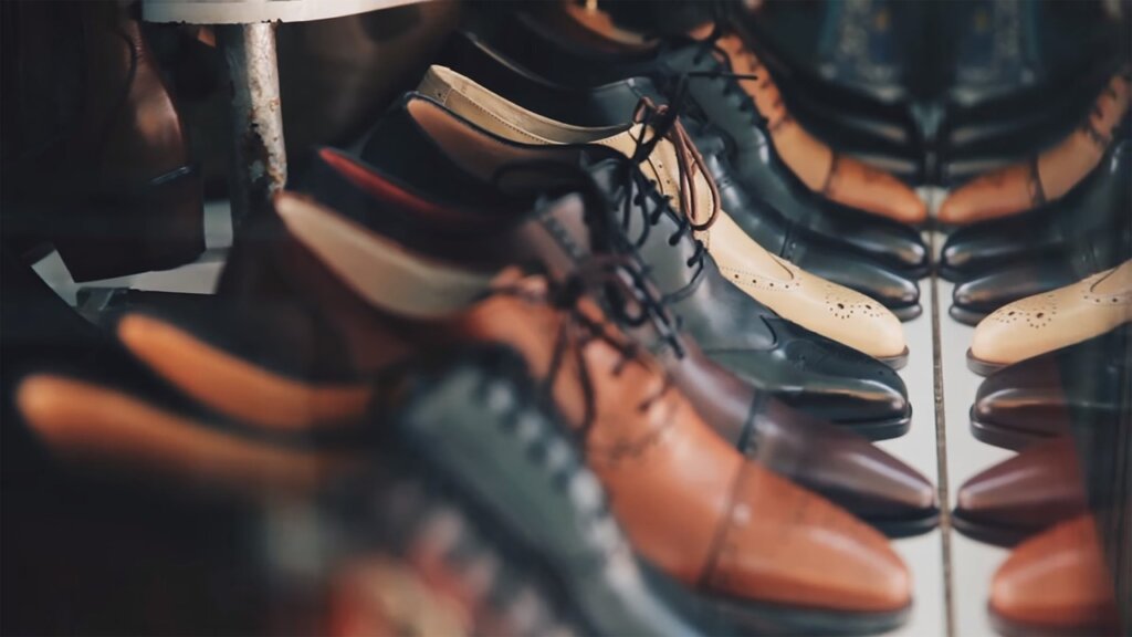 step-style shoe organizer rack inside a shoe cabinet with two rows of sneakers