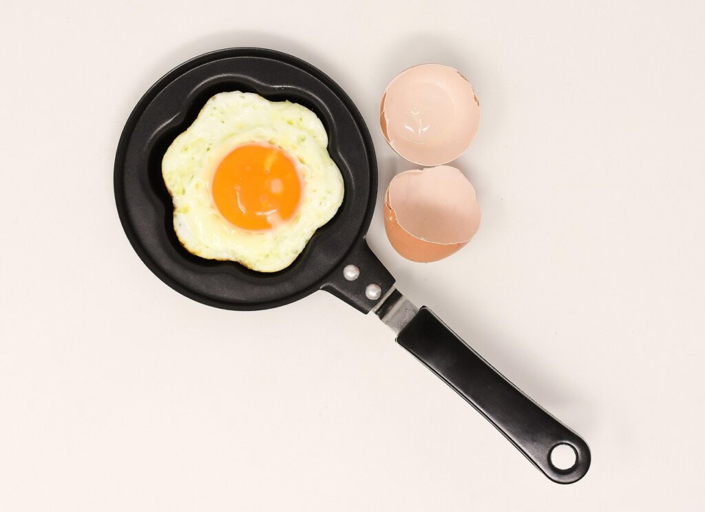 four types of frying pans comparison flat lay