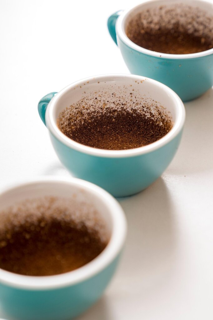 dried coffee grounds on white paper towel drying process