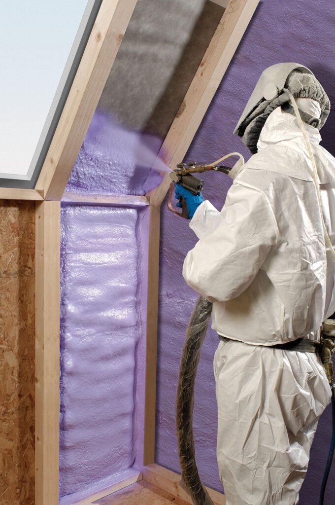 applying silicone sealant to window frame for insulation