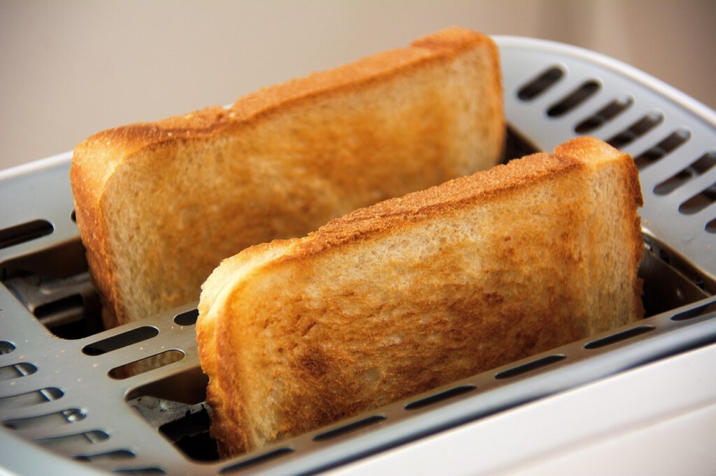 frozen bread slice being toasted in toaster