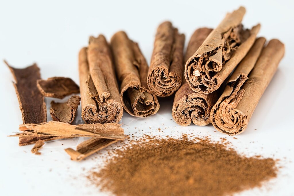 cinnamon powder and lemon slices on white kitchen counter