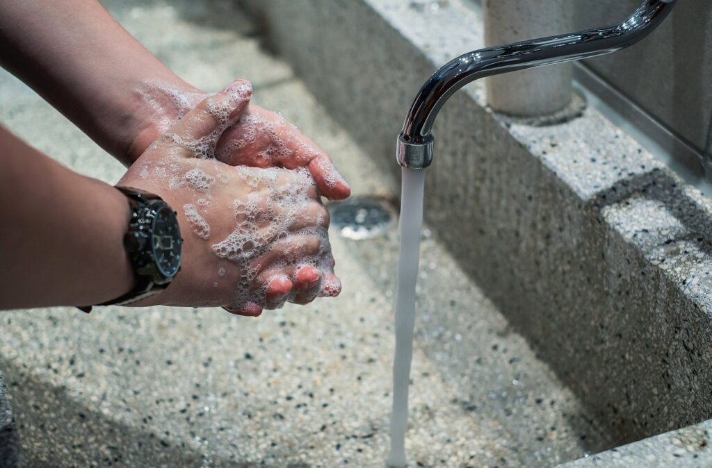 rinsing a rug with clean water outdoors