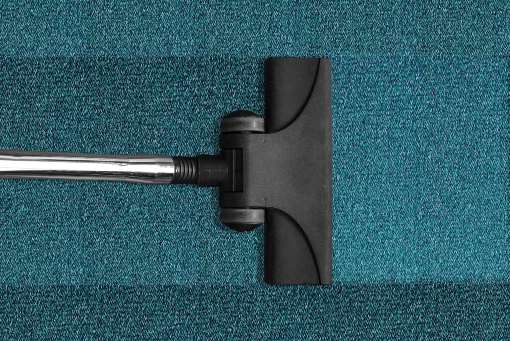 vacuuming air conditioner filter with brush nozzle
