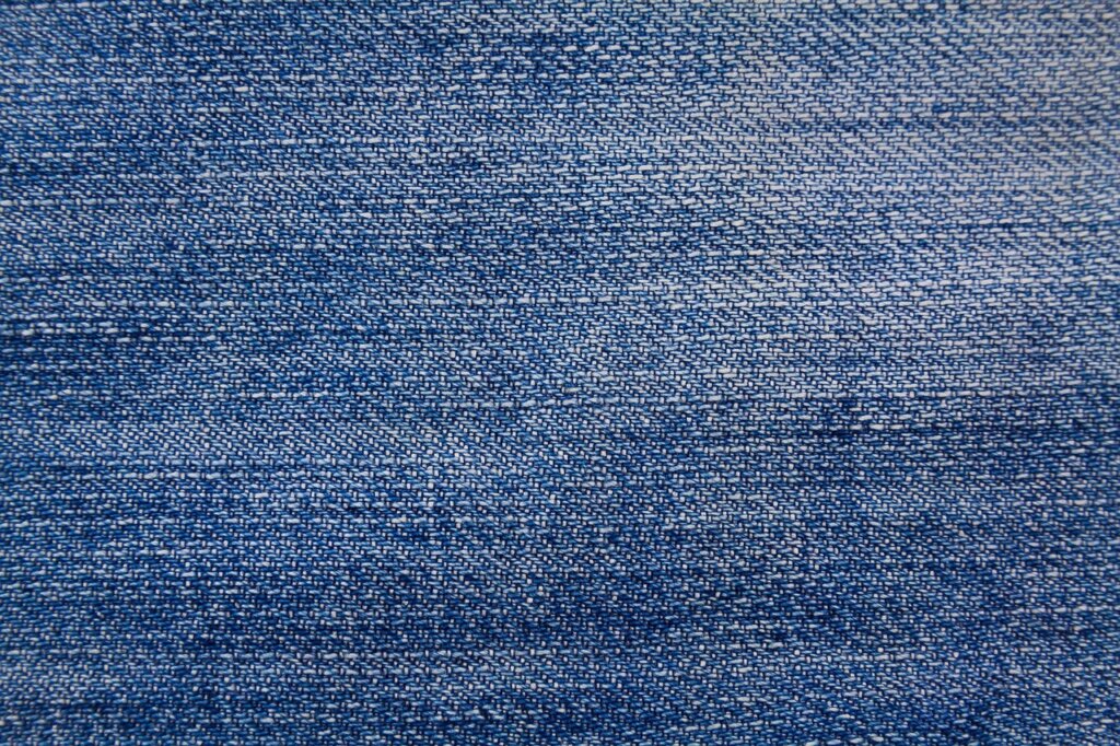 clothing care label being checked with magnifying glass showing fabric symbols