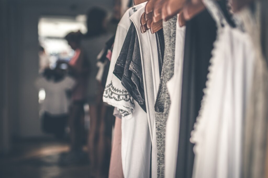 dry cleaning store front with clothes on hangers