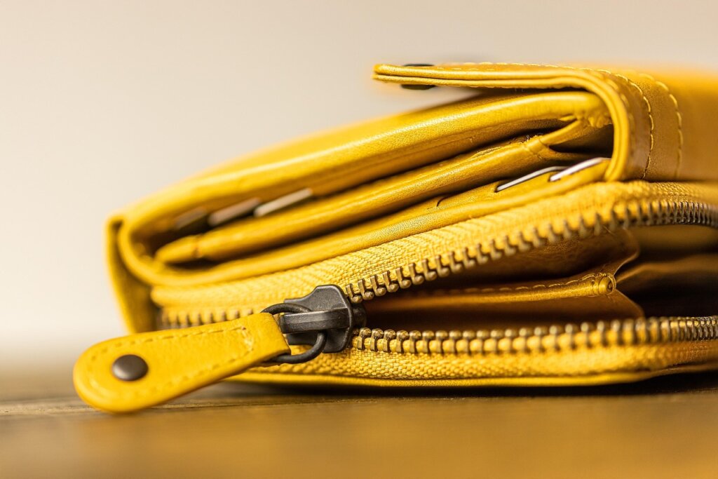 face mask stored flat inside a small zipper pouch on a desk