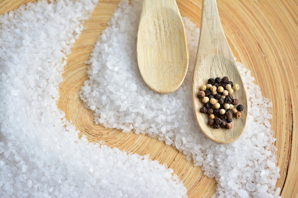 lemon and coarse salt on wooden cutting board for sanitizing