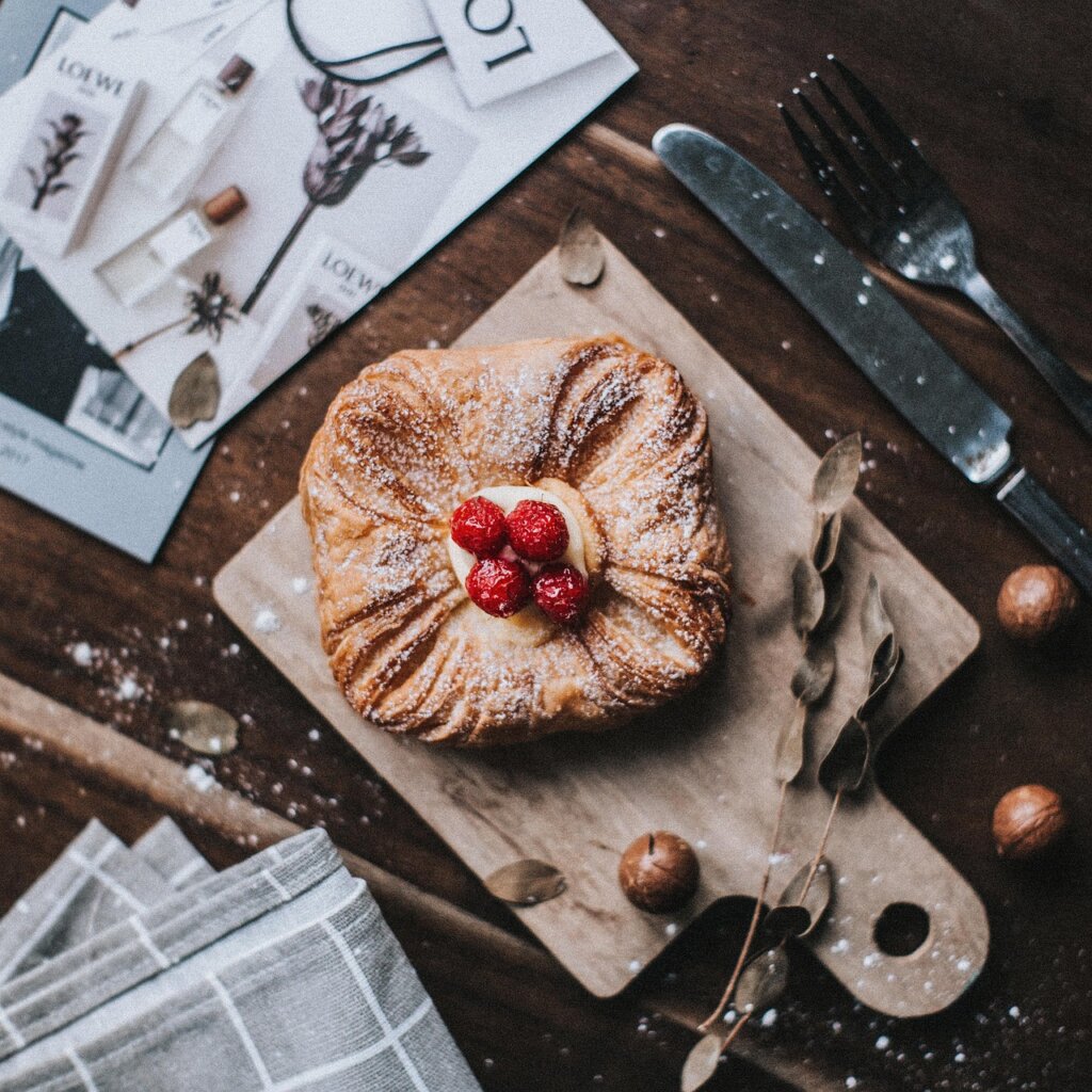 wooden cutting board with visible knife scratches under light