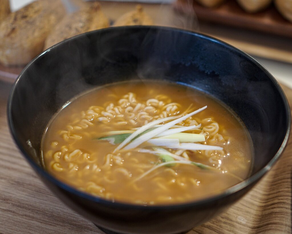 perfectly plated ramen in a bowl with springy noodles and rich broth, overhead shot