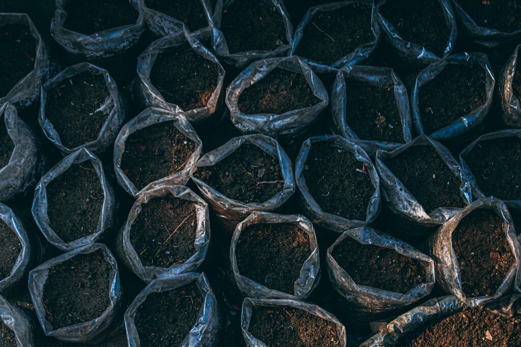 terracotta pot vs plastic pot side by side with soil moisture indicator
