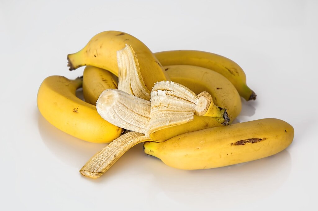 black skin banana cut open showing fresh yellow flesh inside