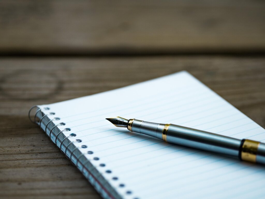 checklist notebook on wooden table with pen in cozy apartment