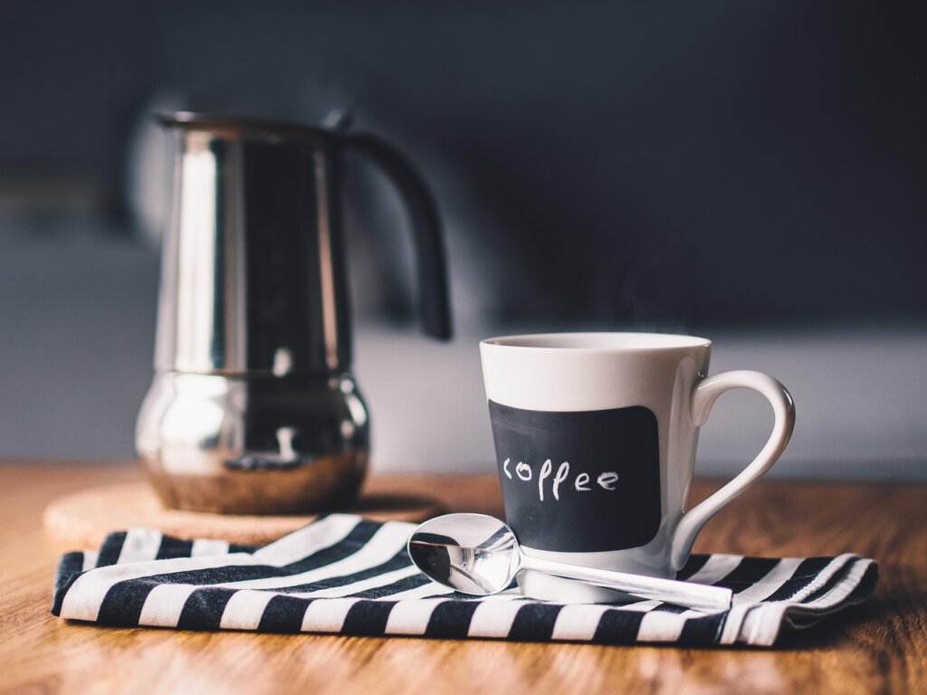 monthly electricity bill showing reduced amount on kitchen table with coffee mug