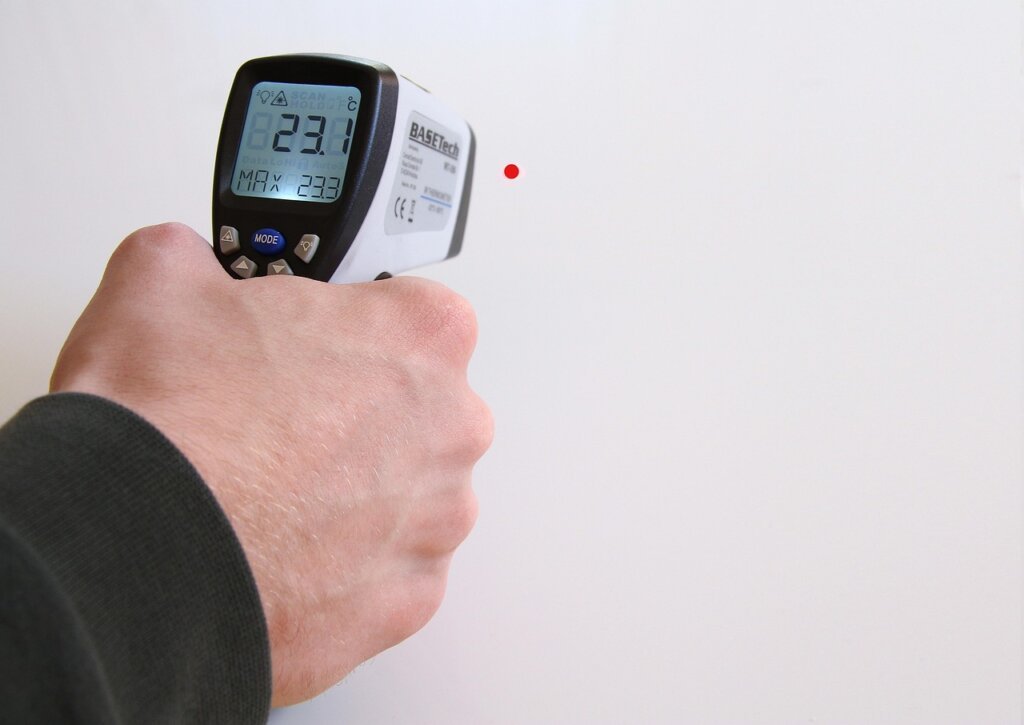 digital thermostat display showing 26 degrees celsius on white wall
