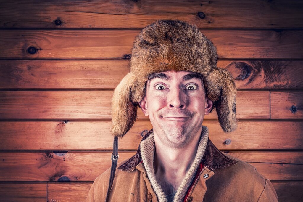 person feeling cold inside air-conditioned room, rubbing arms, uncomfortable expression