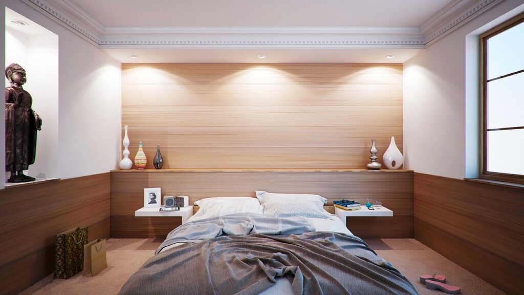 person sleeping comfortably in bedroom with air conditioner running softly, warm dim light