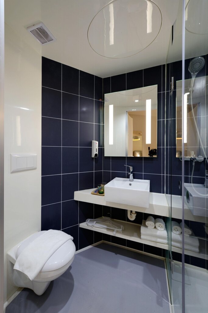 bathroom dehumidifier product and squeegee on shelf