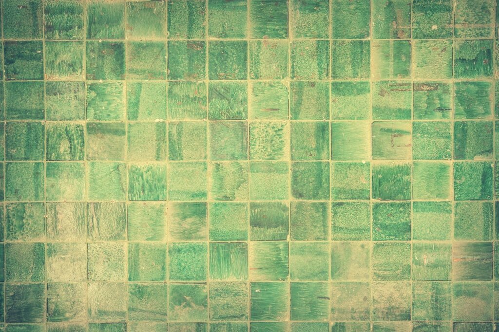 squeegee wiping wet bathroom wall tiles